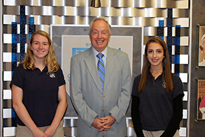 Irene Soteriou and Paige Plucker with a representative of the National Merit Scholarship Program