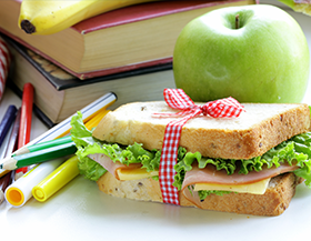 Sandwich and apple with school books