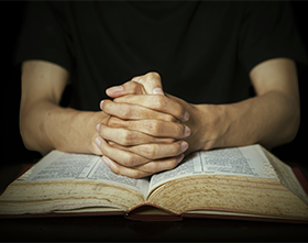 Praying Hands on Bible