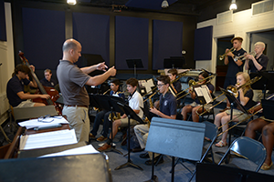 Music teacher and students playing instruments