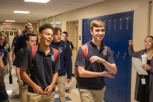 Students walk down a hallway
