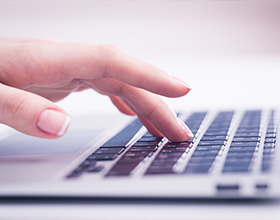 Fingers touch a computer keyboard