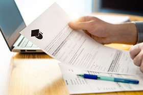Hands holding a college letter