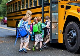 Kids getting on a bus